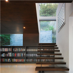 Floating straight staircase with carbon steel stringer  wood glass and steps  