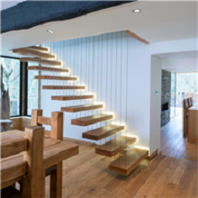 Floating oak wood tread staircase with metal railing