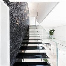 Floating glass tread staircase with glass railing for residential buildings