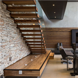 Floating staircase with carbon steel stringer wood steps and glass railing
